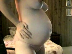 Pregnant Brunette shows off Jugs and Baby Belly